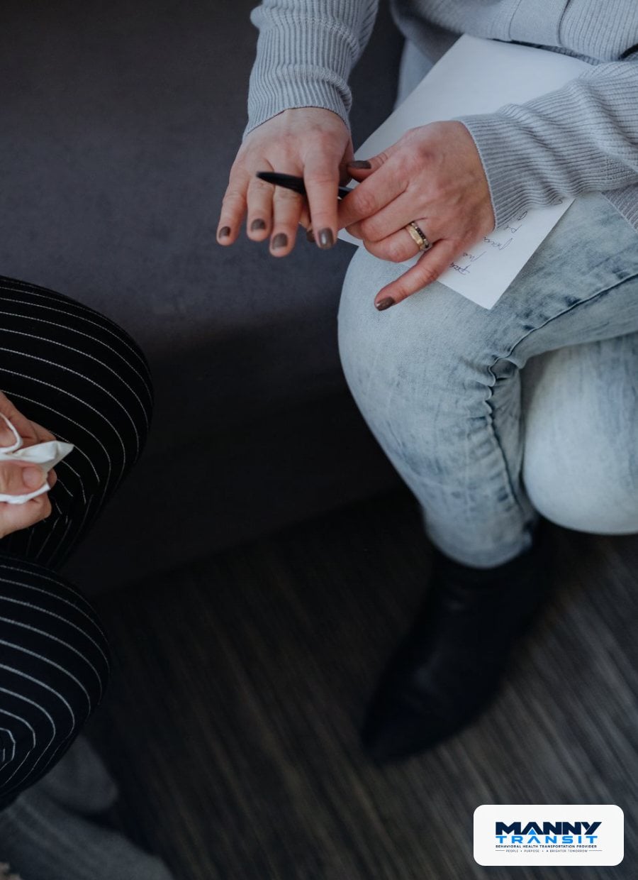 Counselor taking notes during a supportive conversation